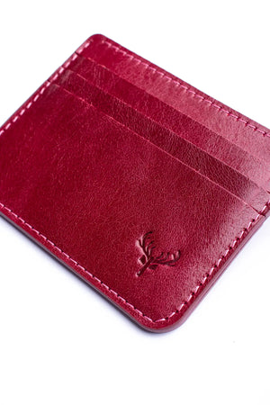 Red leather cardholder with a brand logo on a white background