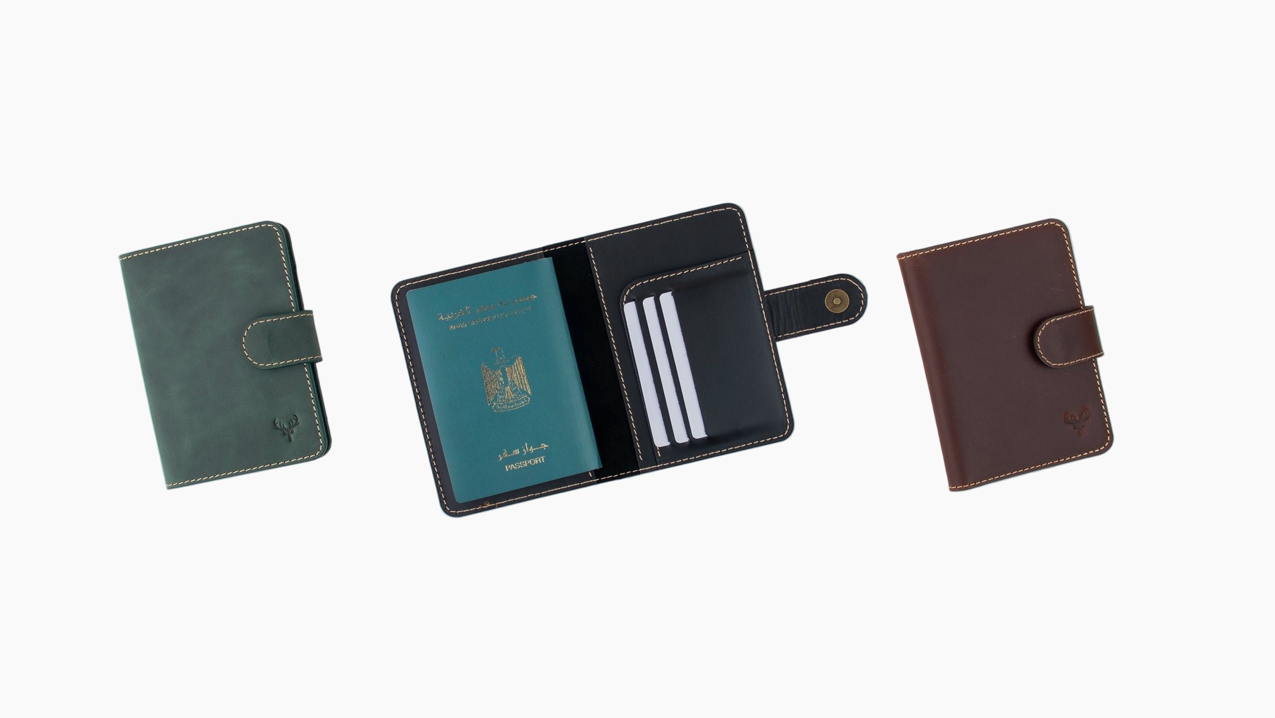 Three leather wallets in different colors on a light gray background

