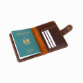 Brown leather passport holder with a green passport on a white background